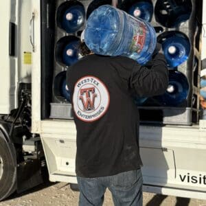 A man holding a water bottle in his hand.